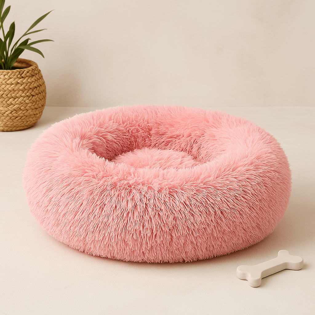 Calming Donut Bed for Pets in soft pink color, perfect for dogs and cats to snuggle and sleep comfortably.